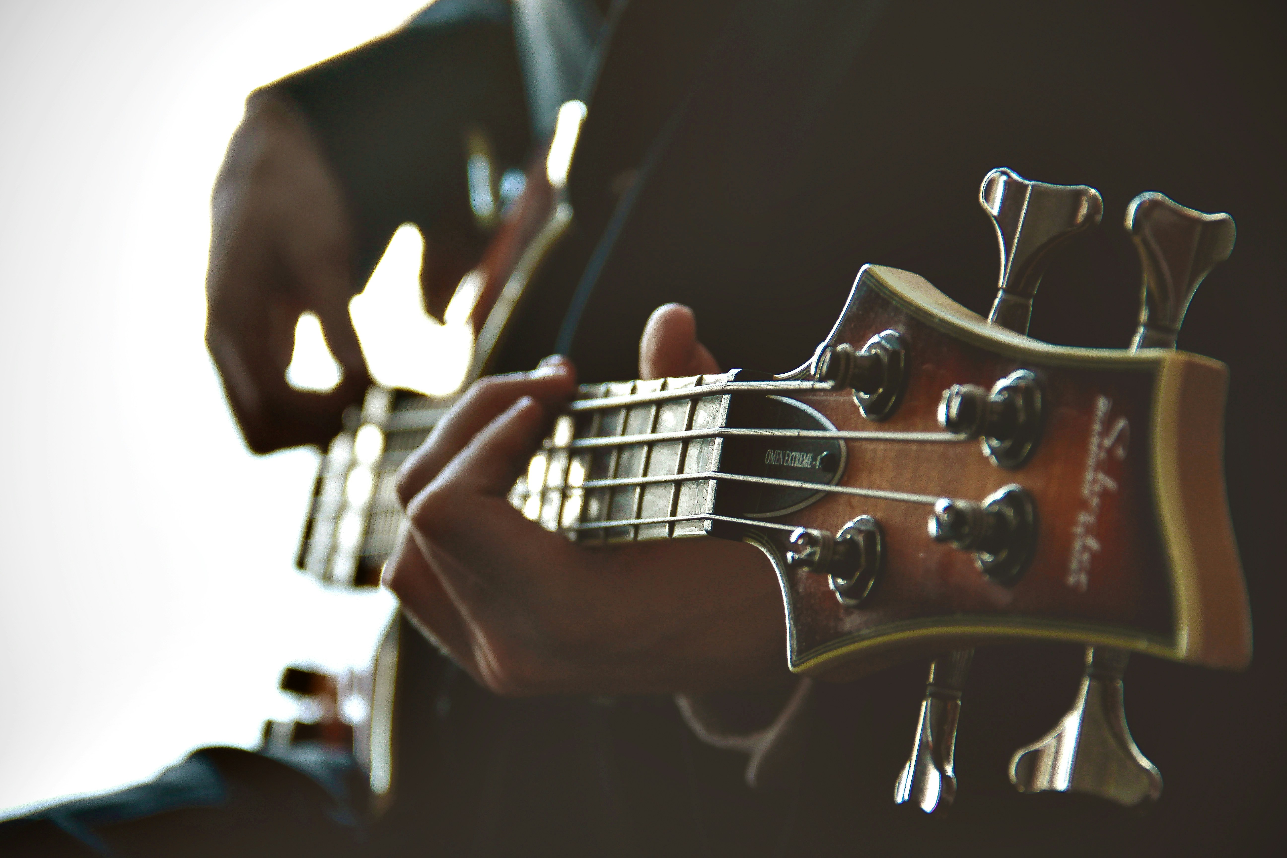 Close detail of a bass guitar being played
